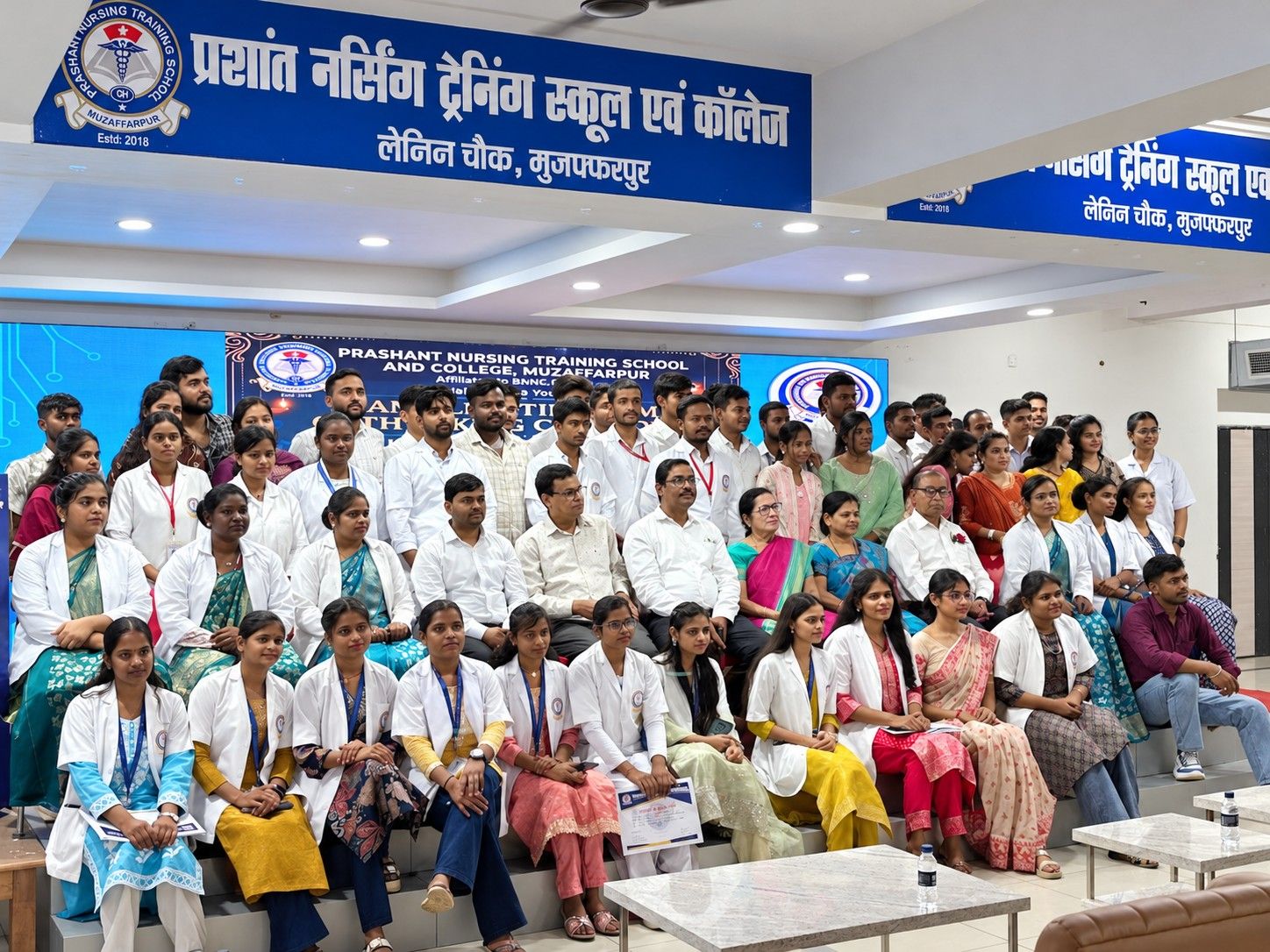Students and faculty at a college ceremony in the auditorium
