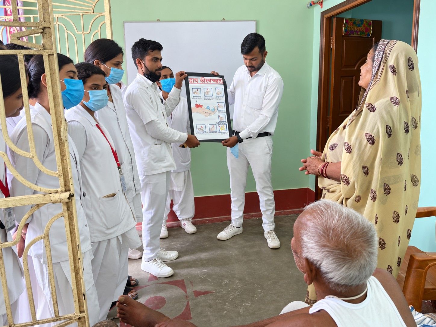 Students teach a family about hand hygiene during a home visit