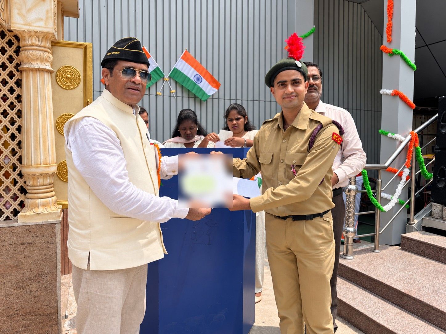 An NCC cadet receives recognition from the Managing Director