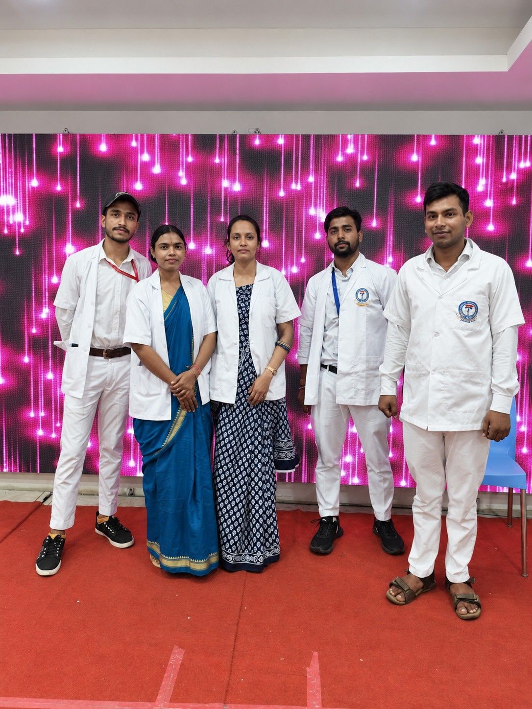 Students in white coats at a college event